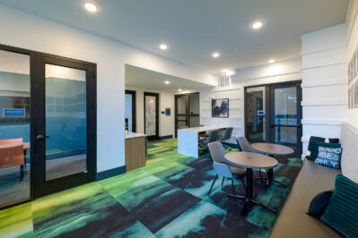 Academic lounge with multiple study stations and private work rooms