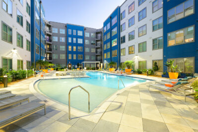 Resort style pool surrounded by lounge chairs
