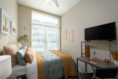 Furnished bedroom with a large window