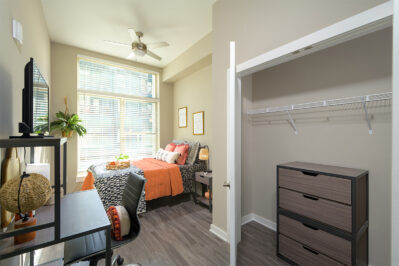 Furnished bedroom with a large closet