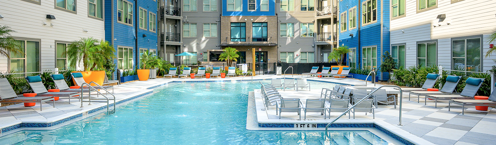 Resort style pool surrounded by lounge chairs